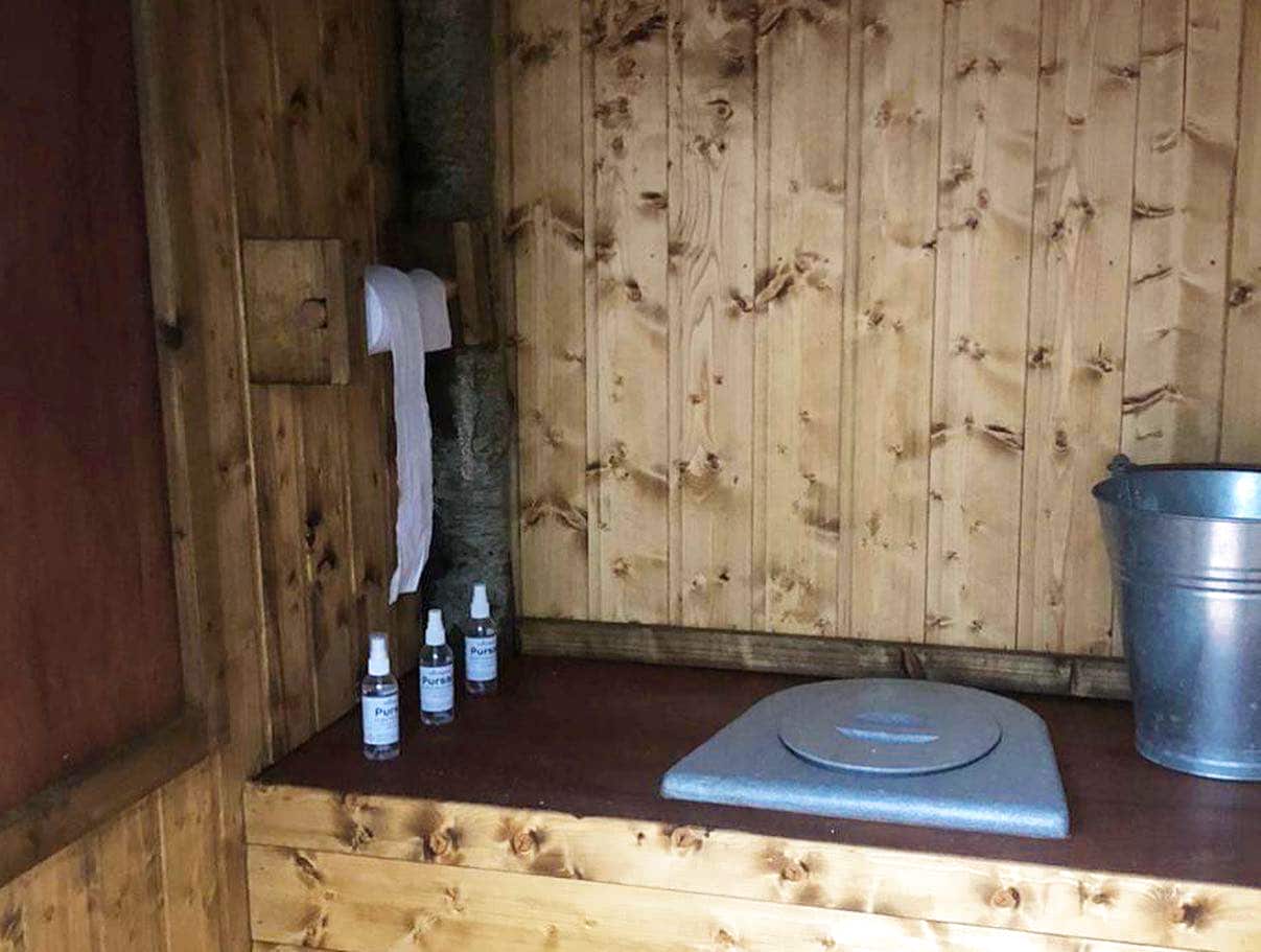 Inside of the toilet cubicle at Finnebrogue Woods, featuring the WooWoo GT waterless composting toilet