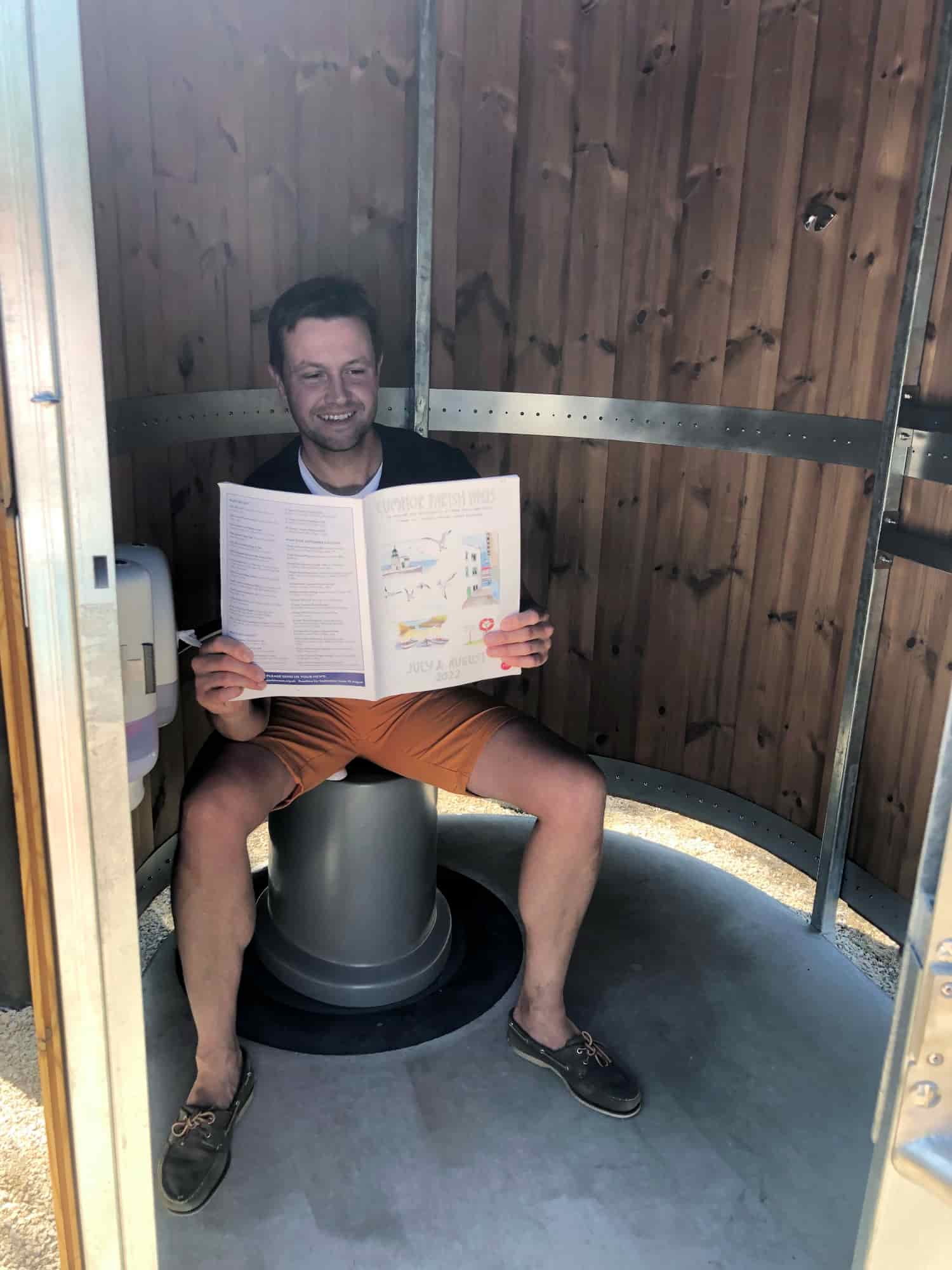 Person sitting on the seat of a Kazuba KL2 compost toilet at Cumnor